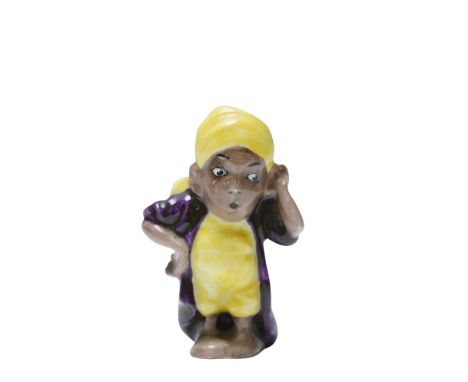 This small figure depicts a character from the 'Arabian Nights' tale 'Ali Baba and the Forty Thieves', with one hand raised t