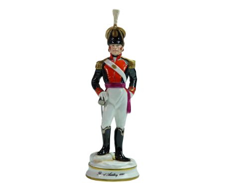 Handcrafted porcelain figurine by Michael Sutty depicting a British Royal Artillery officer in full uniform. The officer stan