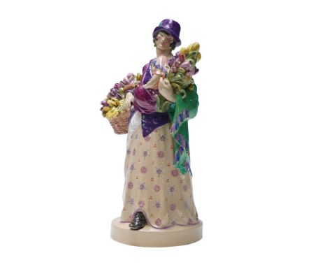 Depicting a standing female vendor in period dress holding baskets overflowing with tulips. A young child rests in her left a
