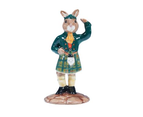 The figure depicts a standing rabbit dressed in traditional Scottish attire, including a green jacket and matching tam hat, r
