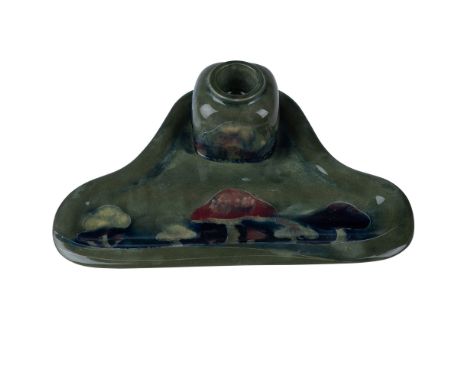 This Moorcroft inkwell and ink pen holder, designed by renowned ceramic artist William Moorcroft, features the iconic toadsto