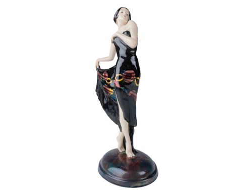 A stunning Art Deco ceramic figurine by Josef Lorenzl for Goldscheider, embodying the elegance and glamour of the 1920s and 1