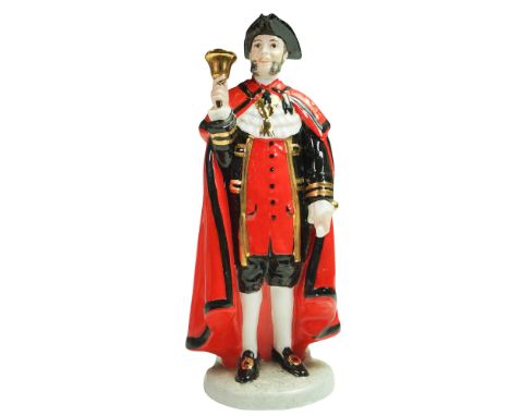 Bone china figure of a traditional English bellman, depicted in formal attire with black tricorn hat, red cloak trimmed in bl