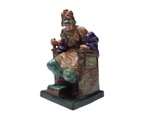 A variation in colorway featuring a light brown tunic-style shirt beneath a blue and red robe. The figure is depicted seated,