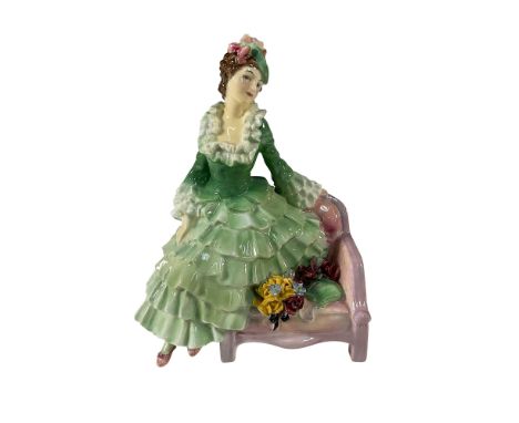 A charming Royal Doulton figurine designed by celebrated artist Leslie Harradine. The figurine depicts an elegant lady seated