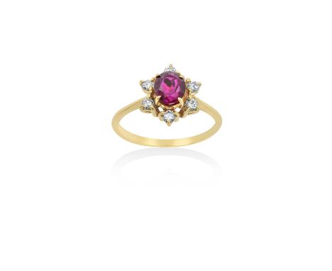 An 18 Carat Gold Ruby and Diamond Cluster Ringthe round cut ruby within a border of round brilliant cut diamonds, in yellow c