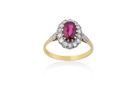 An 18 Carat Gold Synthetic Ruby and Diamond Cluster Ringthe oval cut synthetic ruby within a border of round brilliant cut di