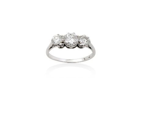 A Diamond Three Stone Ringthe graduated round brilliant cut diamonds in white claw settings, to a tapered shoulder plain poli