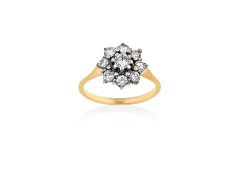 A Diamond Cluster Ringthe central raised round brilliant cut diamond within a border of further round brilliant cut diamonds,