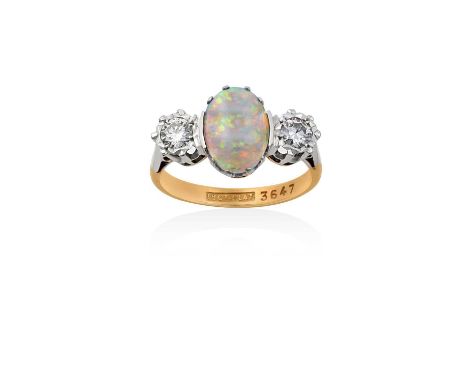 An Opal and Diamond Three Stone Ringthe oval cabochon opal in a white claw setting, flanked by two round brilliant cut diamon