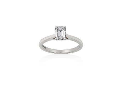 A Platinum Diamond Solitaire Ringthe emerald-cut diamond in a four claw setting, to a tapered shoulder plain polished shank, 