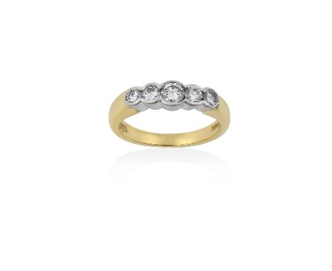 An 18 Carat Gold Diamond Five Stone Ringthe graduated round brilliant cut diamonds in white rubbed over settings, to a yellow