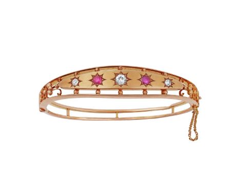 A Ruby and Diamond Banglethe central tapered plaque comprising of three graduated old cut diamonds alternating with two round