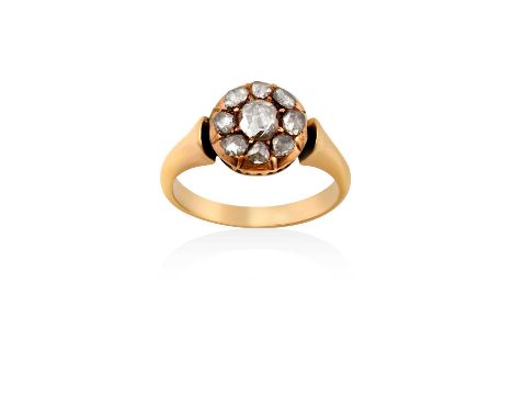 A Diamond Cluster Ring the central rose cut diamond within a border of smaller rose cut diamonds, in yellow claw settings, to