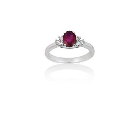 An 18 Carat White Gold Synthetic Ruby and Diamond Ringthe oval cut synthetic ruby flanked by trios of round brilliant cut dia