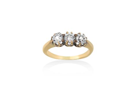 A Diamond Three Stone Ringthe old cut diamonds in yellow claw settings, to a tapered shoulder plain polished shank, total est