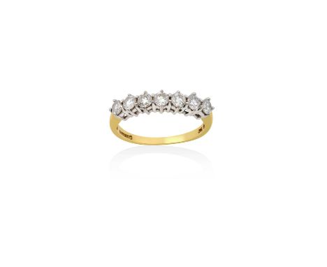 An 18 Carat Gold Diamond Seven Stone Ringthe seven round brilliant cut diamonds in white claw settings, to a yellow plain pol