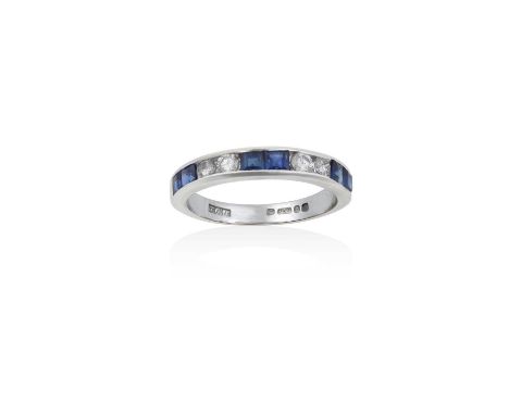 An 18 Carat White Gold Sapphire and Diamond Half Hoop Ringpairs of calibré cut sapphires alternate with pairs of round brilli