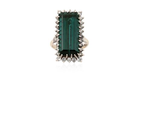 An 18 Carat White Gold Green Tourmaline and Diamond Cluster Ringthe rectangular step cut green tourmaline within a border of 