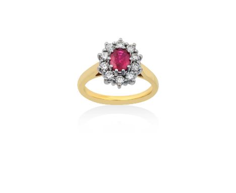 An 18 Carat Gold Ruby and Diamond Cluster Ringthe oval cut ruby within a border of round brilliant cut diamonds, in white cla