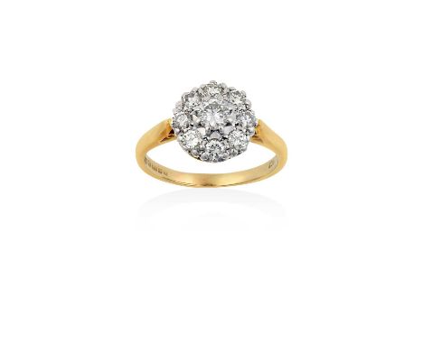 An 18 Carat Gold Diamond Cluster Ringthe central raised round brilliant cut diamond within a border of round brilliant cut di