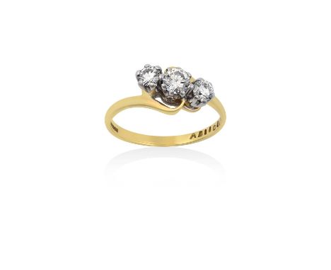 An 18 Carat Gold Diamond Three Stone Twist Ringthe graduated round brilliant cut diamonds, in white claw settings, to a yello