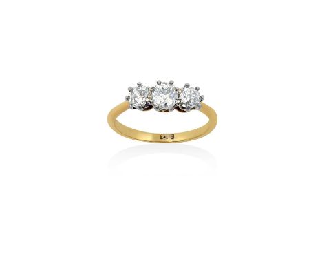 A Diamond Three Stone Ringthe graduated old cut diamonds in white claw settings, to a yellow tapered shoulder plain polished 