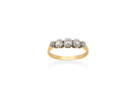 A Diamond Five Stone Ringthe graduated old cut diamonds in white claw settings, to a yellow tapered shoulder plain polished s