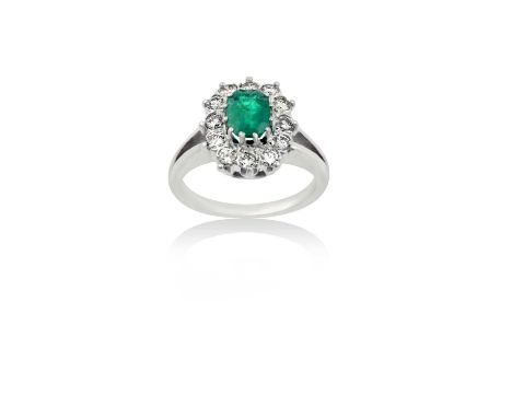 An Emerald and Diamond Cluster Ringthe emerald-cut emerald within a border of round brilliant cut diamonds, in white claw set