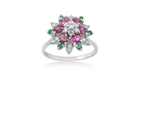 A Ruby, Emerald and Diamond Cluster Ringthe central raised round brilliant cut diamond within a triple stepped border of roun