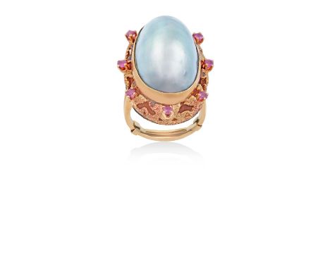 A Mother-of-Pearl and Synthetic Ruby Cluster Ringthe oval domed mother-of-pearl in a yellow rubbed over setting, to a texture