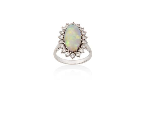 An Opal and Diamond Cluster Ringthe oval cabochon opal within a border of round brilliant cut diamonds, in white claw setting