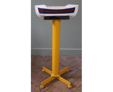 A cast metal 1960's RNLI charity collection box in the form of a lifeboat on yellow painted stand