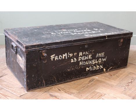 A vintage military style tin trunk