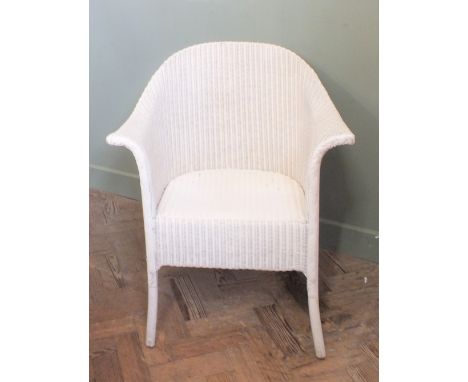 A white painted Loom style chair and a black metal storage trunk