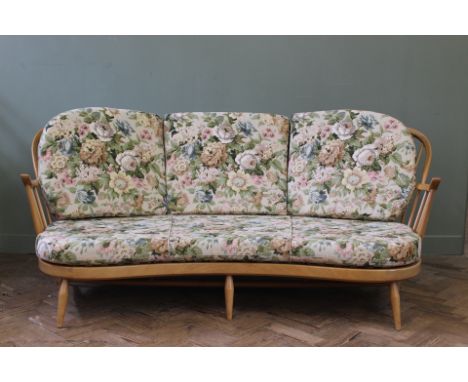 A blonde Ercol kidney shaped three seater sofa