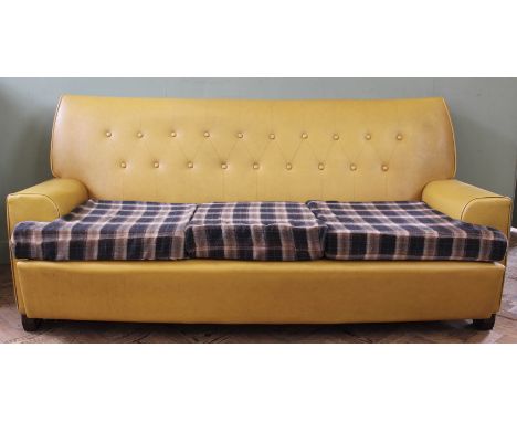 A 1960's mustard vinyl button back sofa with checked seat cushions