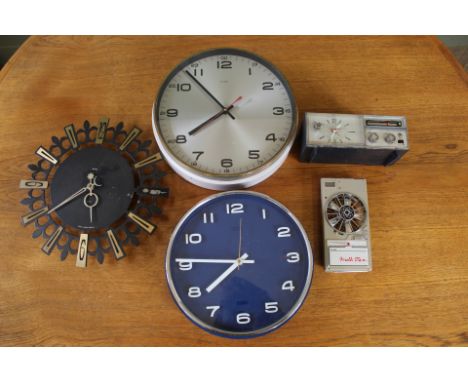 Two Metamec clocks (one white and one blue), a Smith wall clock, a Bush clock radio and a Walk Fan Super