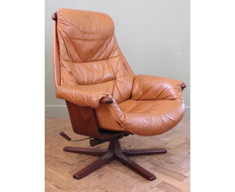 A vintage Swedish Mobel swivel armchair in tan leather