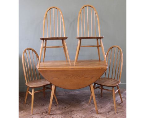 A 1970's light Ercol dining table and four hoop back chairs