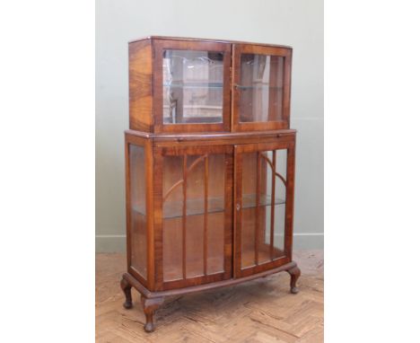 A 1930's china display cabinet with pull out shelf on cabriole legs