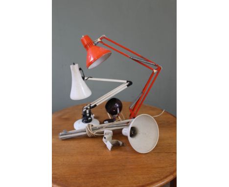 An orange anglepoise lamp, a white anglepoise lamp and two others