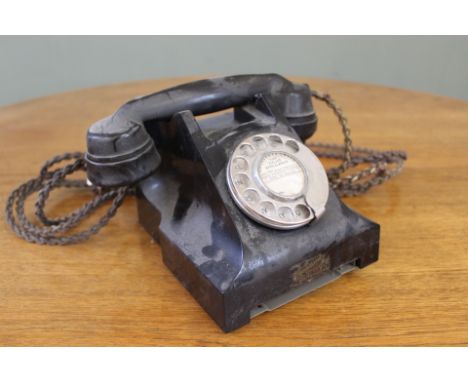A vintage black bakelite telephone