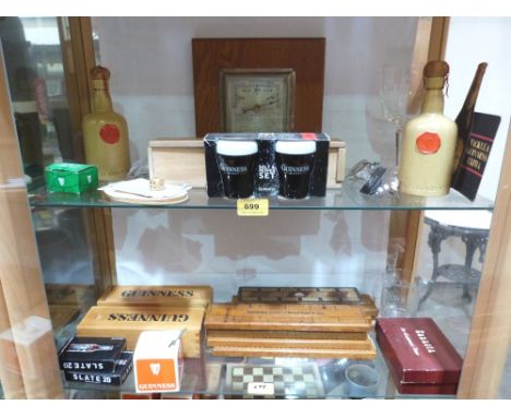 A collection of Guinness themed games and other memorabilia, the lot to include an aneroid barometer