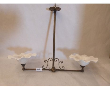 An Edwardian brass two light hanging lamp with crimped shades. 24' wide