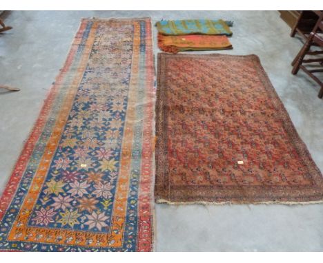 An eastern rug; a carpet runner and two woollen throws