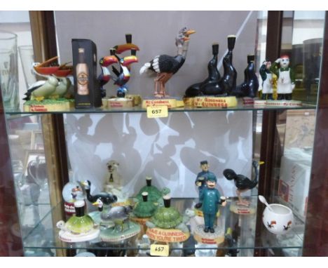 A collection of Guinness themed resinous and ceramic figures to include some Carlton Ware examples