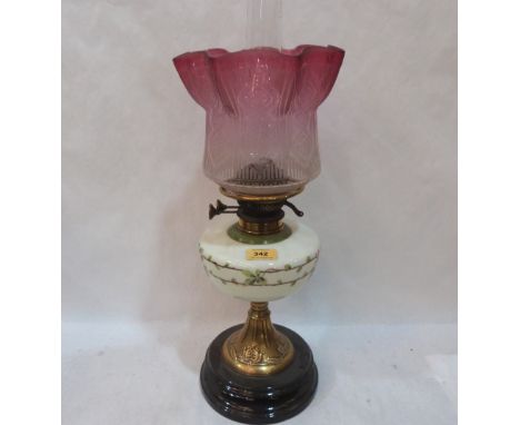 A Victorian oillamp with milch-glass fount painted with flowers and ruby flashed acid etched shade (chipped) on brass and sla