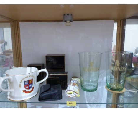A collection of Guinness memorabilia to include a ceramic tyg, a pair of cufflinks, badges, glassware, binoculars etc.