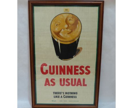 A framed Guinness print on textile, 'Guinness As Usual'. 30' x 18'